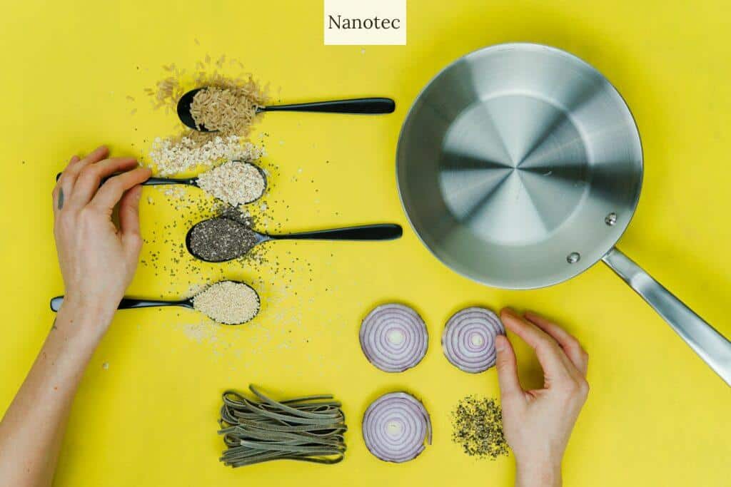 flat lay photography of saute skillet beside spoon of spices and vegetables