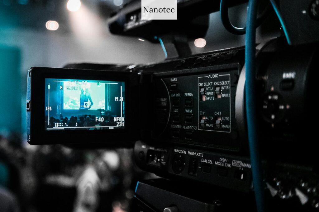 HD video camera capturing a live event; focus on screen and controls.