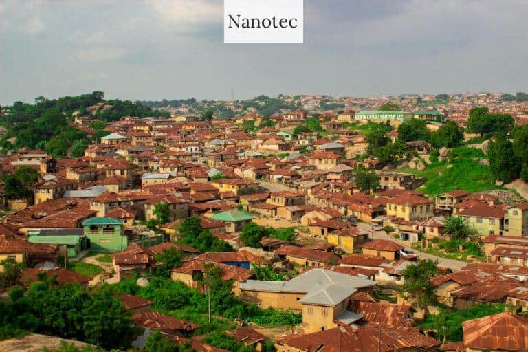 Aerial view of rustic rooftops in Abeokuta, Nigeria with greenery.