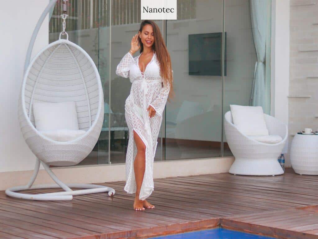 woman in white and pink floral dress standing on brown wooden floor