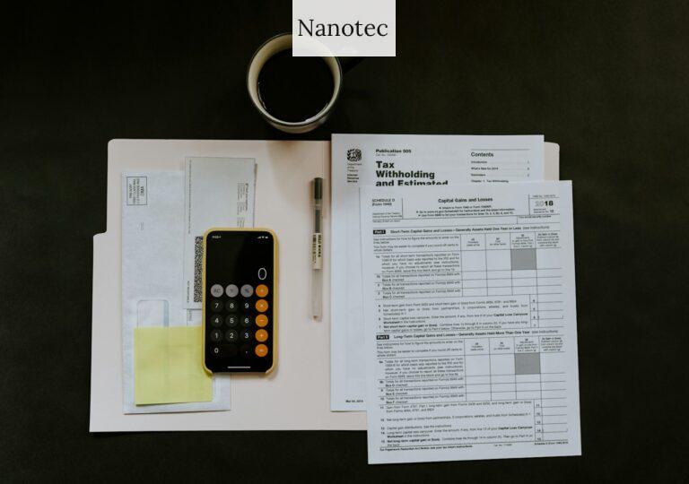 black Android smartphone near ballpoint pen, tax withholding certificate on top of white folder
