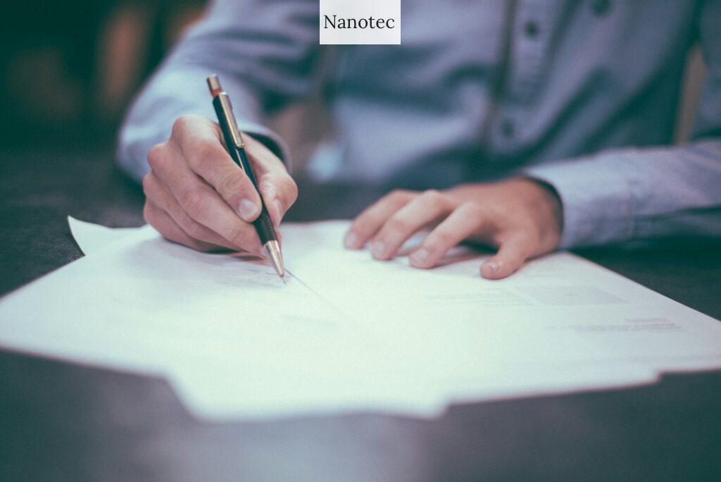 man writing on paper